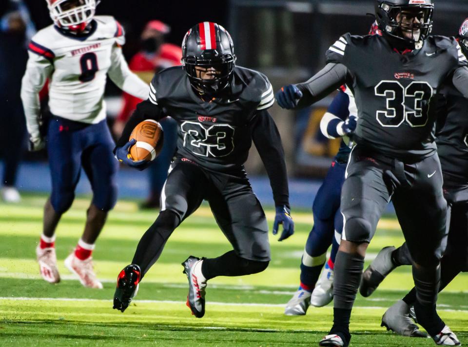 Aliquippa's Tiqwai Hayes runs for yards against McKeesport in the WPIAL Class 4A semifinal game Friday at Canon McMillan High School. [Lucy Schaly/For BCT]