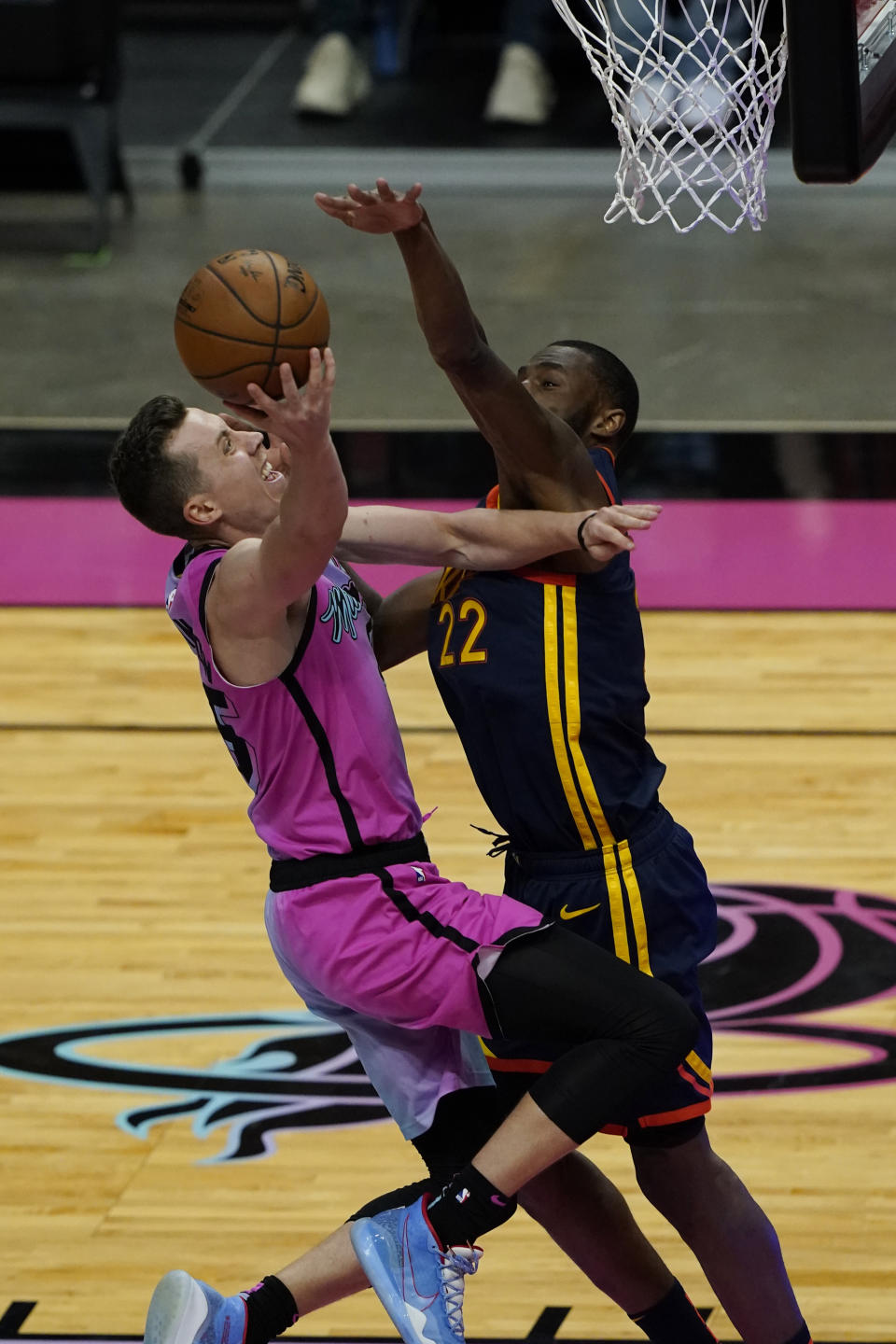 Miami Heat guard Duncan Robinson (55) drives to the basket as Golden State Warriors forward Andrew Wiggins (22) defends during the second half of an NBA basketball game, Thursday, April 1, 2021, in Miami. (AP Photo/Marta Lavandier)
