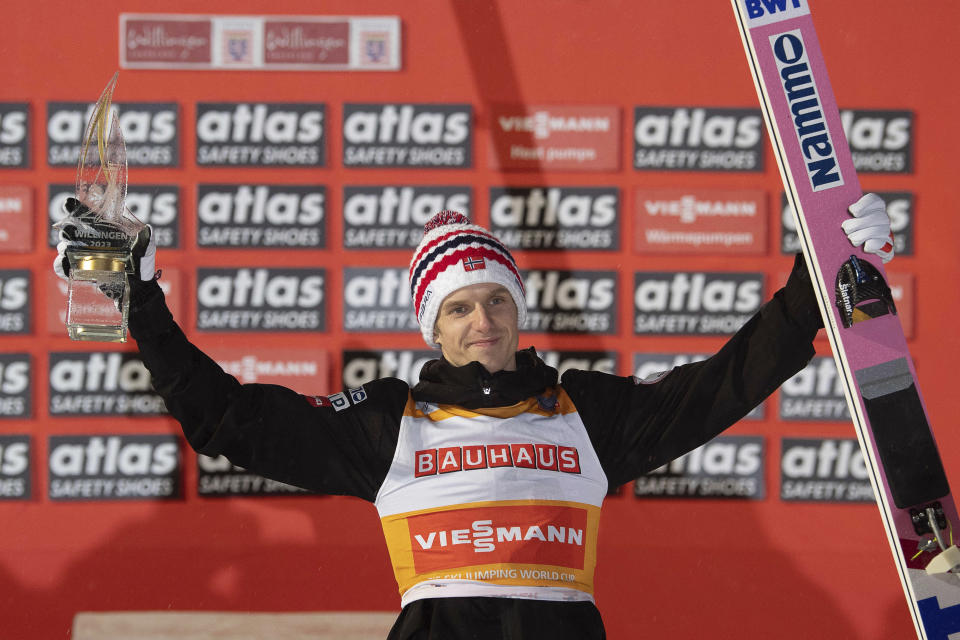 Norway's Egner Granerud, center, winner of the ski jumping, men's World Cup large hill event, poses on the podium in Willingen, Germany, Sunday, Feb. 5, 2023. (Swen Pfoertner/dpa/dpa via AP)