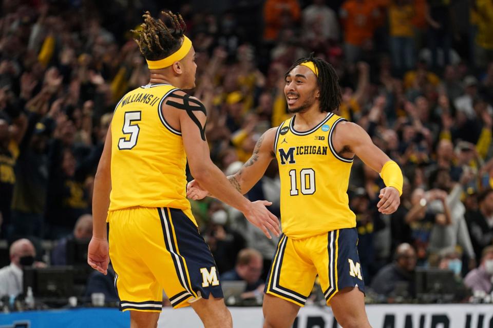 Michigan Wolverines guard Frankie Collins (10) celebrates a play with Michigan Wolverines forward Terrance Williams II (5) during the second round of the 2022 NCAA Tournament at Gainbridge Fieldhouse.