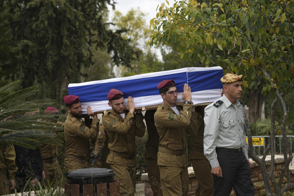 Pallbearers carry the coffin of Israeli Defense Forces Sgt. Rotem Sahar Hadar, a Paratrooper who was killed in action in the Gaza Strip, during his funeral at the military cemetery in Gedera, Israel, Friday, Feb. 16, 2024. (AP Photo/Tsafrir Abayov)