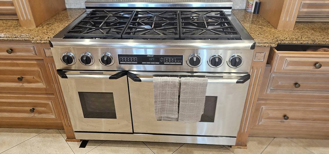 A gas stove and other kitchenware, like dishwashers and pot racks and cabinets and granite counters are up for auction on Dec. 23, 2023, from inside La Maison Blanche before it gets torn down after the 2024 New Year.