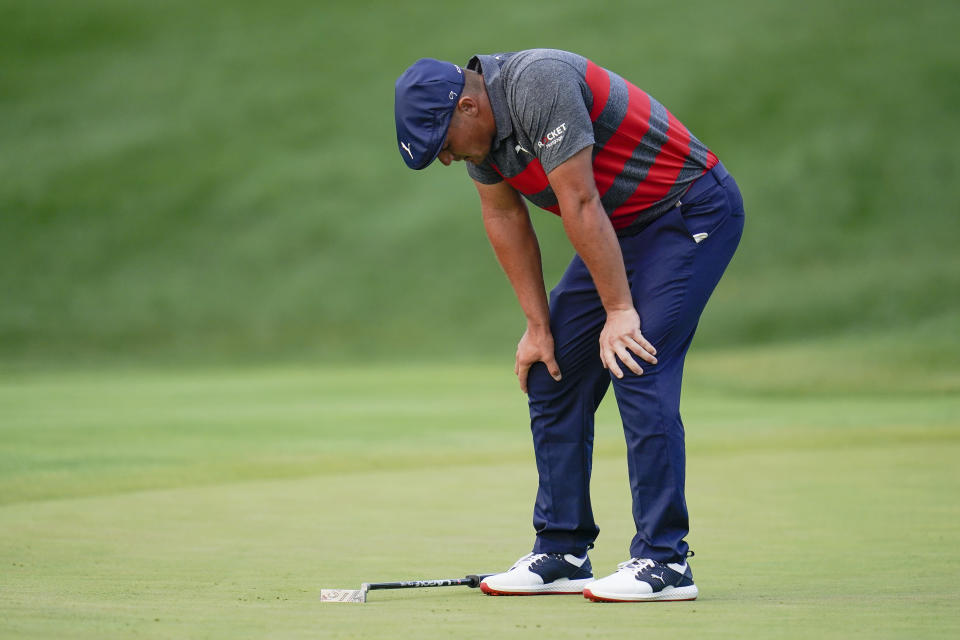 Bryson DeChambeau reacts after missing a putt on the 17th green, the third playoff hole against Patrick Cantlay during the final round of the BMW Championship golf tournament, Sunday, Aug. 29, 2021, at Caves Valley Golf Club in Owings Mills, Md. (AP Photo/Julio Cortez)