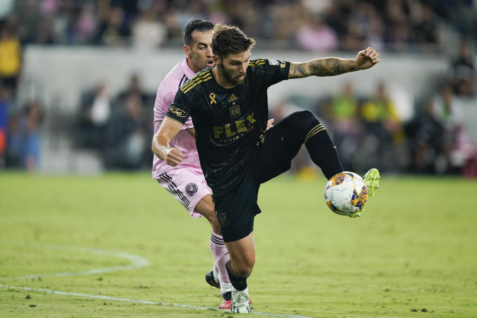 Los Angeles FC midfielder Ryan Hollingshead, right, traps the ball ahead of Inter Miami midfielder Sergio Busquets, left, during the first half of an MLS soccer match, Sunday, Sept. 3, 2023, in Los Angeles. (AP Photo/Ryan Sun)