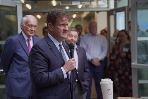 Granite President and CEO Rob Hale addresses the crowd at the ribbon cutting ceremony for Granite’s new headquarters, alongside Senator Ed Markey and Quincy Mayor Thomas P. Koch. (Photo: Business Wire)