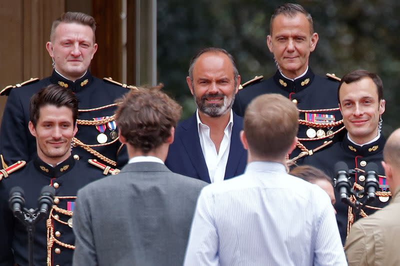 Edouard Philippe, outgoing French Prime Minister, poses with French Republican Guards at Hotel Matignon in Paris