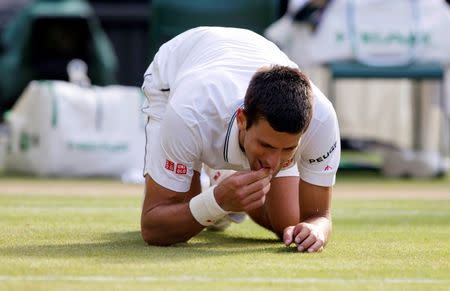 Jul 6, 2014; London, United Kingdom; Novak Djokovic (SRB) celebrates recording match point in his match against Roger Federer (SUI) on day 13 of the 2014 Wimbledon Championships at the All England Lawn and Tennis Club. Susan Mullane-USA TODAY Sports