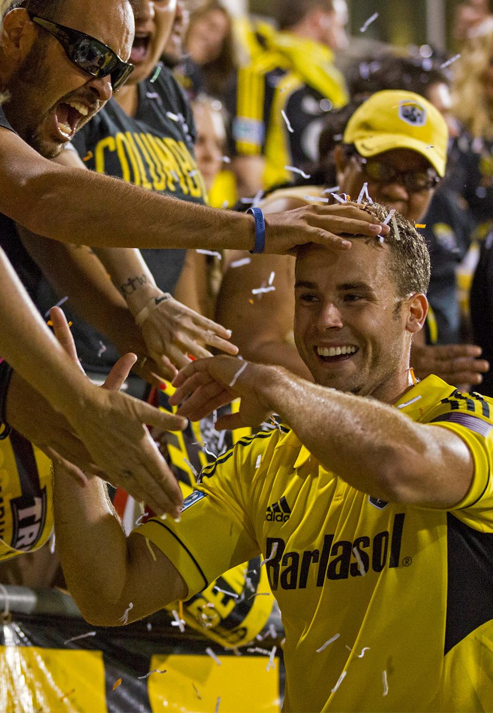 Fans celebrate with Crew defender Josh Williams after a win over Toronto FC in 2013.