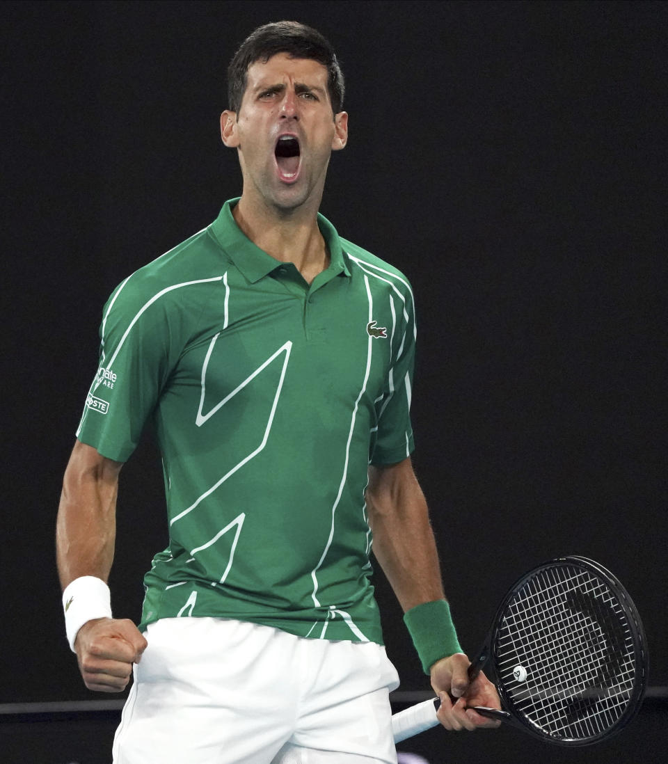 Serbia's Novak Djokovic celebrates after winning the first set against Canada's Milos Raonic during their quarterfinal match at the Australian Open tennis championship in Melbourne, Australia, Tuesday, Jan. 28, 2020. (AP Photo/Lee Jin-man)