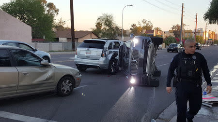 A self-driven Volvo SUV owned and operated by Uber Technologies Inc. is flipped on its side after a collision in Tempe, Arizona, U.S. on March 24, 2017. Courtesy FRESCO NEWS/Mark Beach/Handout via REUTERS