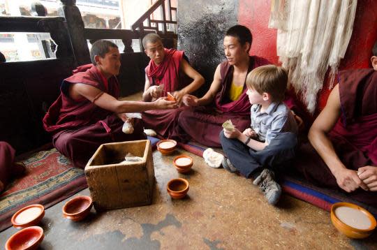 On the Friendship Highway in Tibet, the family visited a monastery and sat with monks drinking sweet tea. “They were amazed to see our boys there,” says Bruce. “In so many cultures, the elders and the youth are seen as treasures of society. The boys sensed that.” (Photo: Bruce Kirkby/Travel Channel)