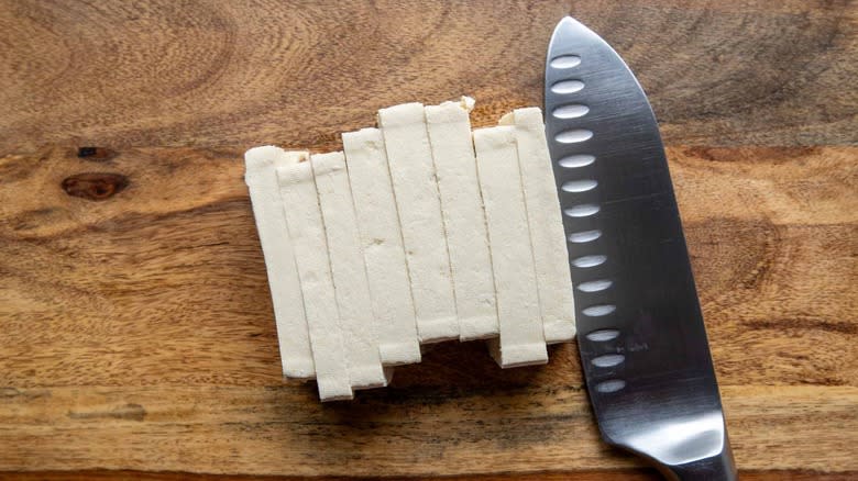 slicing tofu on cutting board