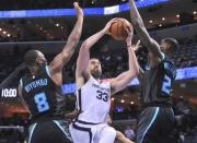 Jan 23, 2019; Memphis, TN, USA; Memphis Grizzlies center Marc Gasol (33) drives to the basket against Charlotte Hornets center Bismack Biyombo (8) and forward Marvin Williams (2) during the second half at FedExForum. Charlotte defeated Memphis 118-107. Mandatory Credit: Justin Ford-USA TODAY Sports