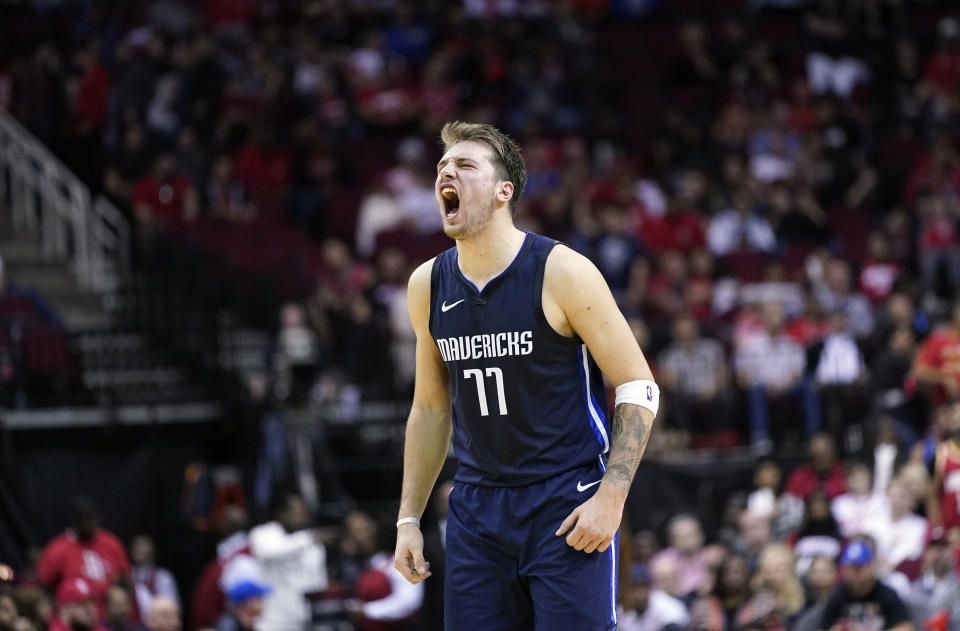 Dallas Mavericks' Luka Doncic reacts after a teammate's 3-pointer against the Houston Rockets during the second half of an NBA basketball game Sunday, Nov. 24, 2019, in Houston. The Mavericks won 137-123. (AP Photo/David J. Phillip)