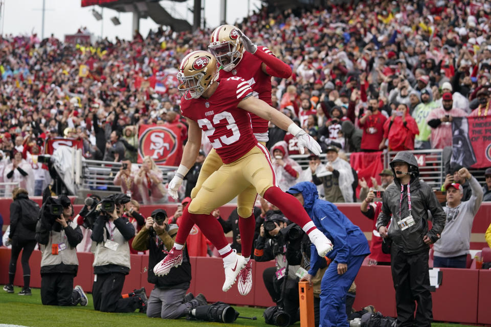 San Francisco 49ers running back Christian McCaffrey (23) is congratulated by wide receiver Jauan Jennings after scoring against the Seattle Seahawks during the first half of an NFL wild card playoff football game in Santa Clara, Calif., Saturday, Jan. 14, 2023. (AP Photo/Godofredo A. Vásquez)