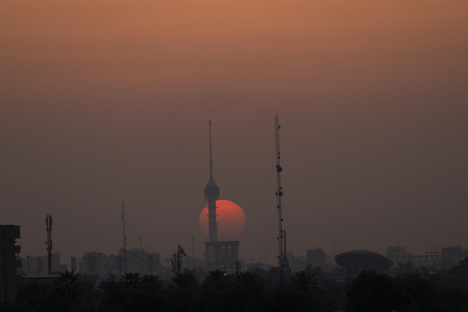 The sun sets over Baghdad, Iraq, on Thursday, March 2, 2023. A U.S.-led war twenty years ago deposed a dictator whose imprisonment, torture and execution of dissenters had kept 20 million people living in fear for a quarter of a century. But it also broke what had been a unified state at the heart of the Arab world. (AP Photo/Jerome Delay)