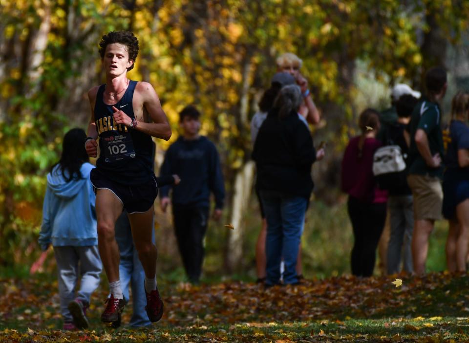 Div. 2 regional cross country champion Nate Carmody nears the finish line clocking 16:11.7 during the MHSAA Div. 3 Cross Country regional at DeWitt, Friday, Oct. 27, 2023.