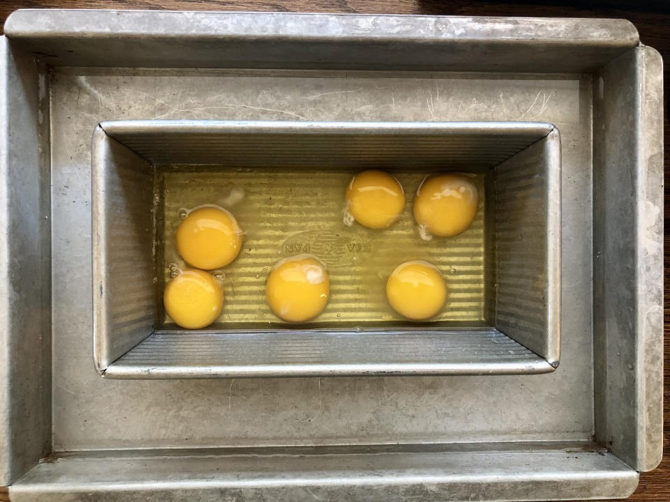 Cracked eggs in a water bath are ready for baking. (Heather Martin)