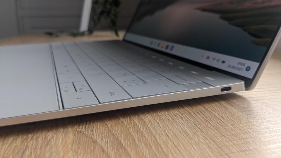 The Dell XPS 13 Plus photographed on a wooden desk.