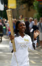 Hannah Agyeman-Prempeh carries the Olympic Flame on the Torch Relay leg between Harlow and Waltham Cross.