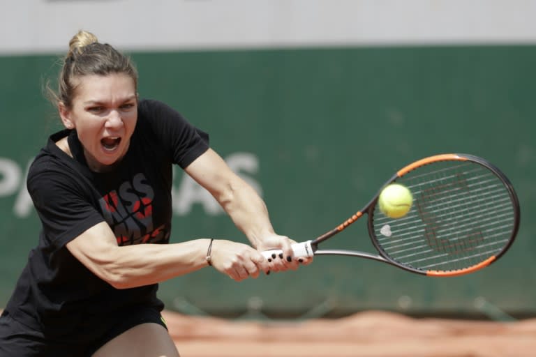 Romania's Simona Halep returns the ball during a training session in Paris on May 24, 2018, ahead of The Roland Garros 2018 French Open tennis tournament