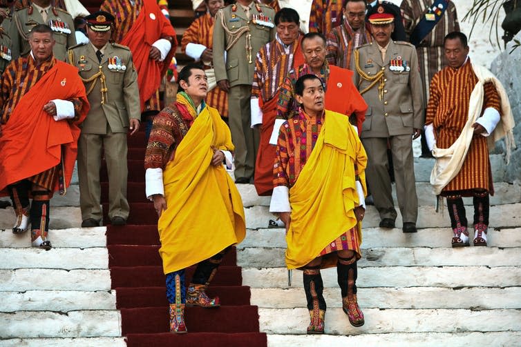 <span class="caption">Jigme Singye Wangchuck, the fourth King of Bhutan (right) and the current king, his son, Jigme Khesar Namgyel Wangchuck (left).</span> <span class="attribution"><a class="link " href="https://www.flickr.com/photos/bhutan-360/3448492328" rel="nofollow noopener" target="_blank" data-ylk="slk:Gelay Jamtsho / flickr;elm:context_link;itc:0;sec:content-canvas">Gelay Jamtsho / flickr</a>, <a class="link " href="http://creativecommons.org/licenses/by-nc-sa/4.0/" rel="nofollow noopener" target="_blank" data-ylk="slk:CC BY-NC-SA;elm:context_link;itc:0;sec:content-canvas">CC BY-NC-SA</a></span>