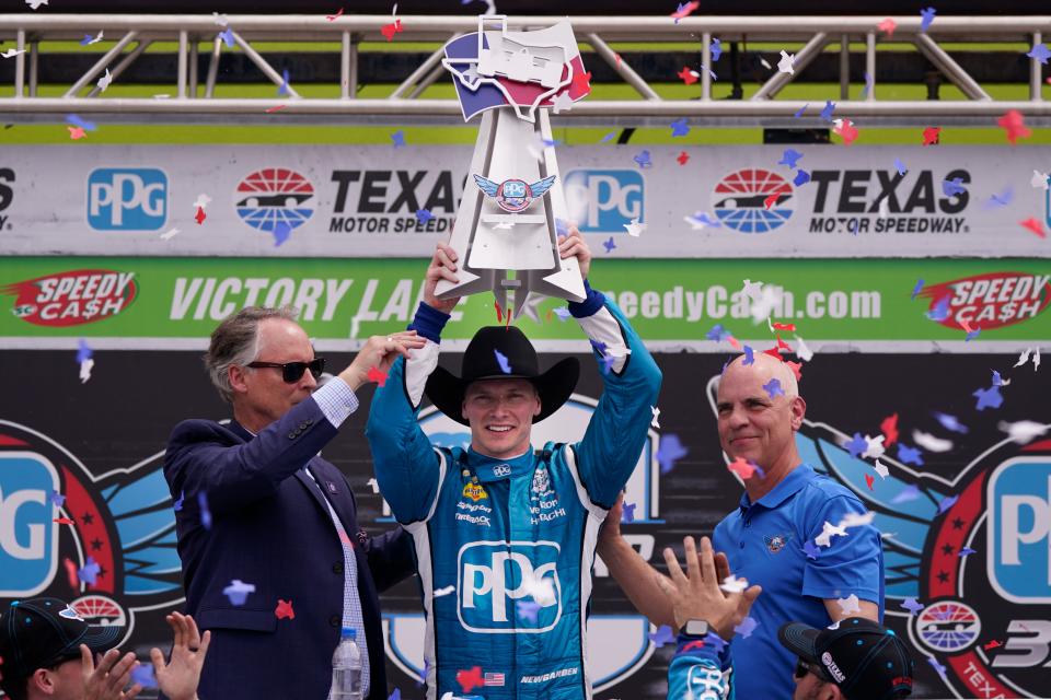 Josef Newgarden, center, celebrates winning the IndyCar auto race at Texas Motor Speedway in Fort Worth, Texas, Sunday, April 2, 2023.