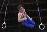 The Russian Olympic Committee's Aleksandr Kartsev performs on the rings during the men's artistic gymnastic qualifications at the 2020 Summer Olympics, Saturday, July 24, 2021, in Tokyo. (AP Photo/Gregory Bull)