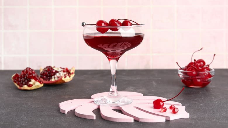 martini glass with pomegranates and cherries