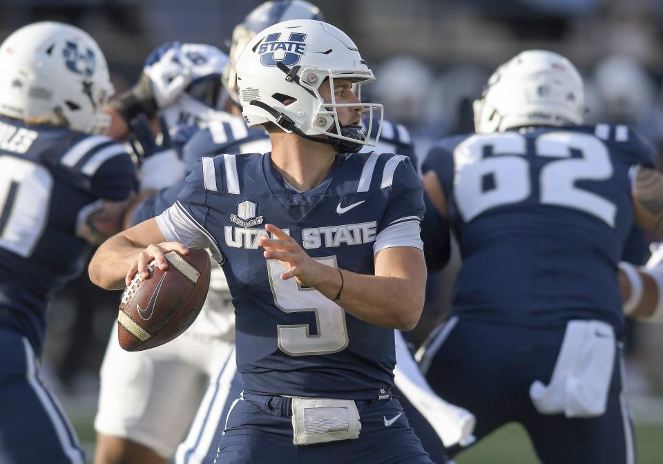 Utah State quarterback Cooper Legas (5) looks for a receiver during the second half of the team’s NCAA college football game against Nevada on Saturday, Nov. 11, 2023, in Logan, Utah. | Eli Lucero/The Herald Journal via AP