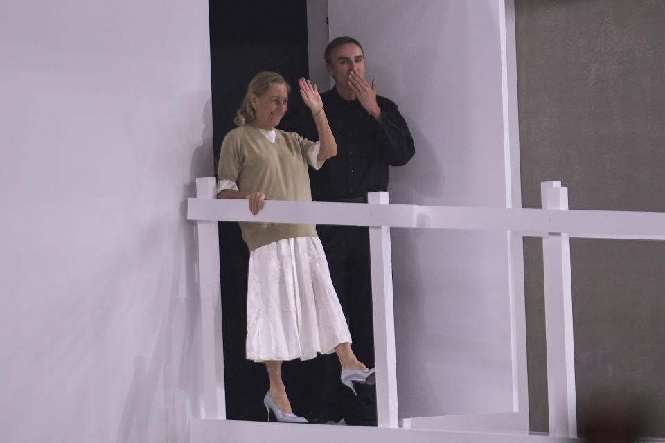 Head designers Miuccia Prada, left, and Raf Simons acknowledge the appluse at the end of the Prada Spring Summer 2025 fashion show, that was presented in Milan, Italy, Sunday, June 16, 2024. (AP Photo/Luca Bruno).