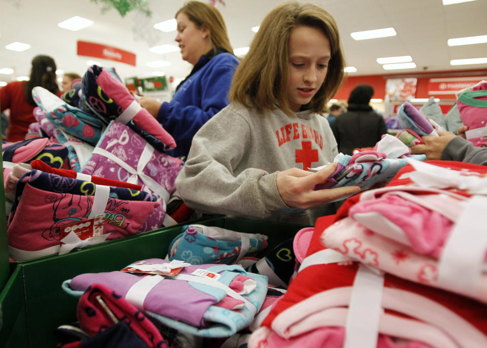 Shoppers look through a bin full of pajamas inside a Target store on the shopping day dubbed 