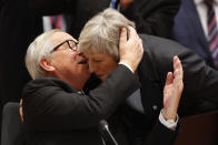 European Commission President Jean-Claude Juncker, left, greets British Prime Minister Theresa May during a round table meeting at an EU summit in Brussels, Thursday, Dec. 13, 2018. EU leaders gathered Thursday for a two-day summit which will center on the Brexit negotiations. (AP Photo/Alastair Grant)