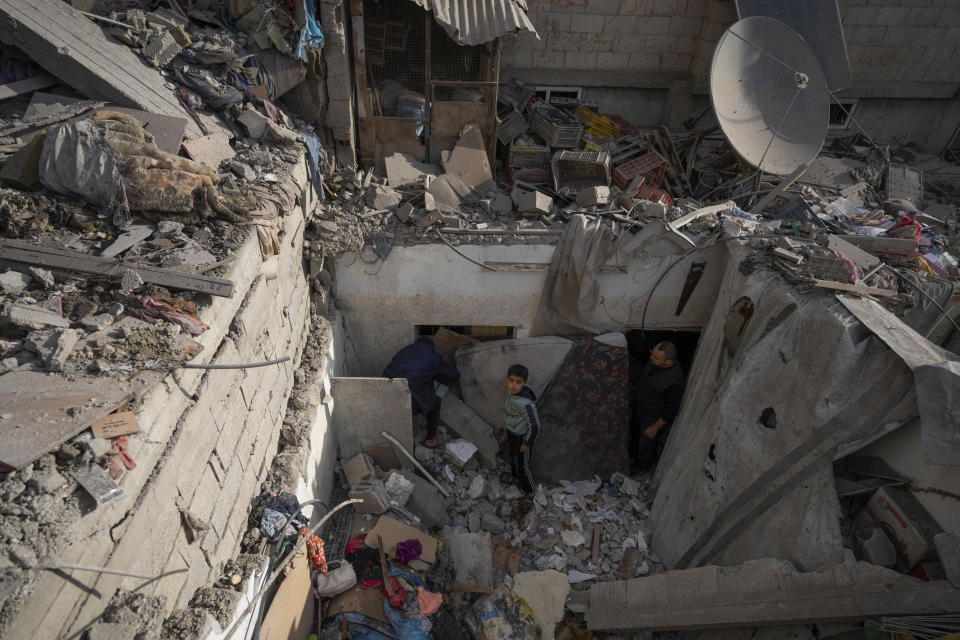 Palestinians look at the destruction after an Israeli strike in Rafah, southern Gaza Strip, Wednesday, Jan. 17, 2024. (AP Photo/Fatima Shbair)