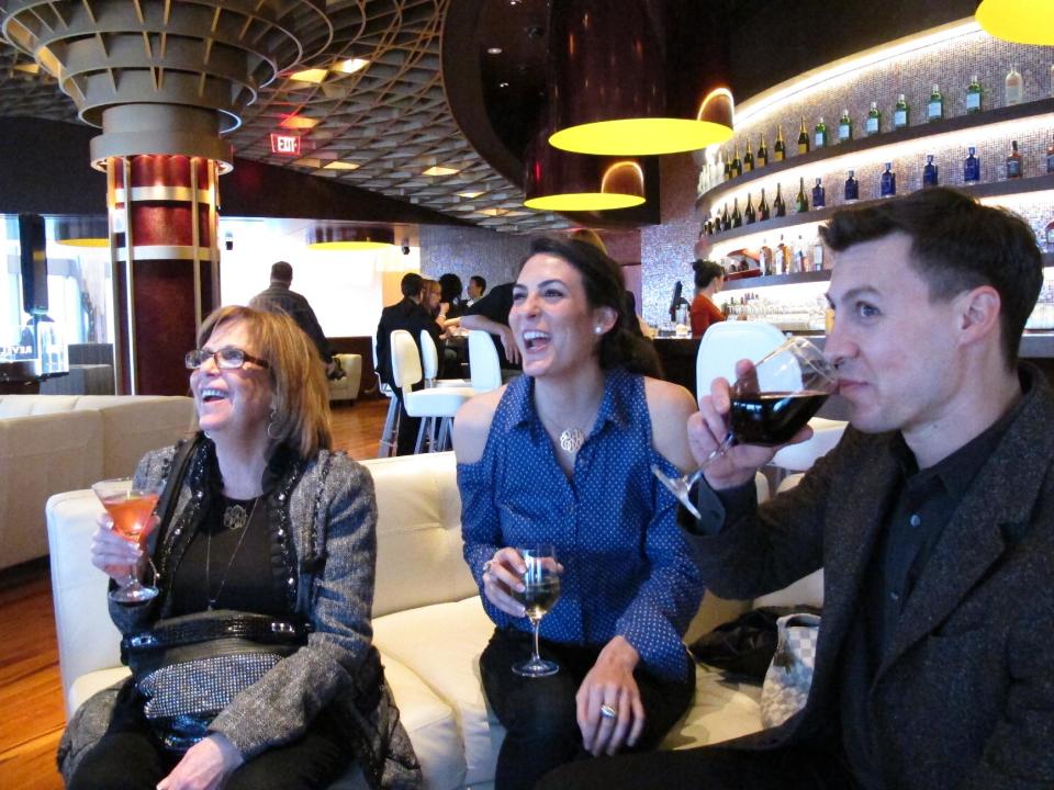 In this March 28, 2012, photo, Sheri Frankel, left, Ashley Frankel, center, both of Margate, N.J., and Todd Gordon, right, of Atlantic City, N.J., enjoy drinks at Revel, the Atlantic City casino that had its first test night on March 28. The $2.4 billion resort opens to the public on Monday, April 2. (AP Photo/Wayne Parry)