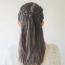 <p>Tie the two braids together at the back of your head. </p>