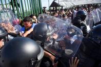 Migrants, part of a caravan travelling to the U.S., clash with Mexican national guards at the border between Guatemala and Mexico, in Ciudad Hidalgo