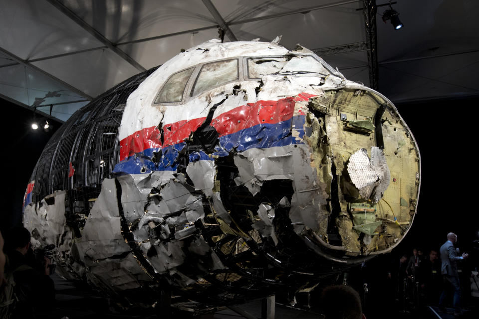 FILE - This Tuesday, Oct. 13, 2015 file photo, shows the reconstructed wreckage of Malaysia Airlines Flight MH17, put on display during a press conference in Gilze-Rijen, central Netherlands. Malaysia Airlines Flight 17 broke up high over Eastern Ukraine killing all 298 people on board. A Dutch safety watchdog says airlines around the world need more and better information to make risk assessments about flying over conflict zones. The Dutch Safety Board issued a report Thursday Feb. 21, 2019, following up on its publication in 2015 of a probe into the cause of the downing of Malaysia Airlines Flight 17 over war-ravaged eastern Ukraine on July 17, 2014. (AP Photo/Peter Dejong, File)