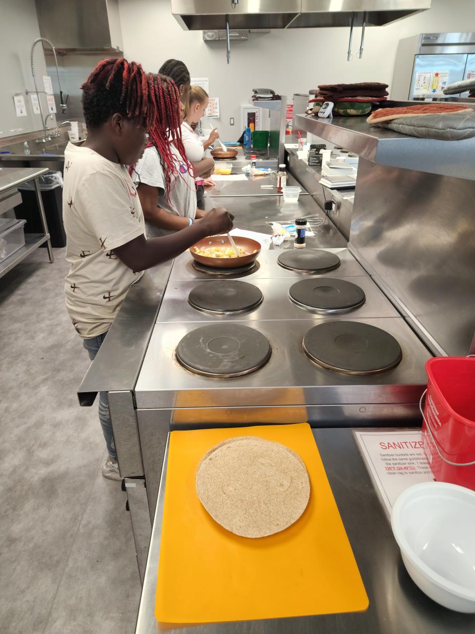 Black Youth Alliance participants take a workshop on healthy recipes and healthy eating during summer 2022 at the University of Wisconsin-Green Bay STEM Innovation Center.