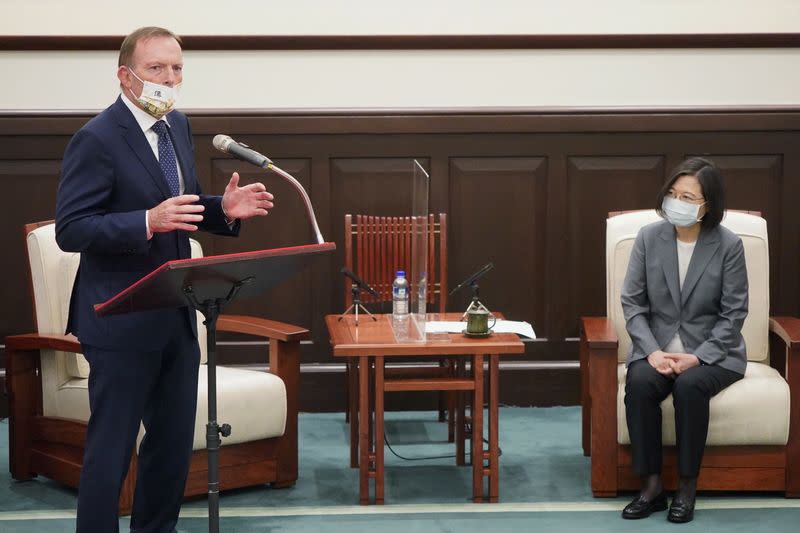 Former Australian Prime Minister Tony Abbott speaks next to Taiwan's President Tsai Ing-wen during their meeting in Taipei