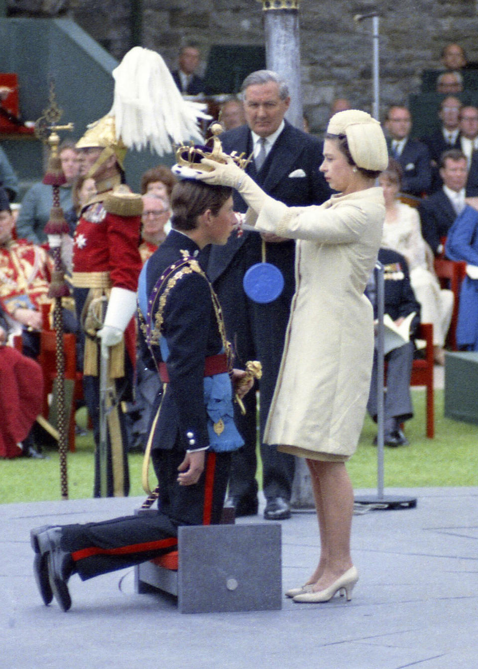 FILE - Queen Elizabeth II crowns her son Charles, Prince of Wales during his investiture ceremony on July 1, 1969 at Caernafon Castle in Wales, as Britain's Home Secretary James Callaghan looks on. (AP Photo, File)