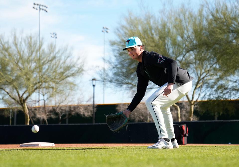 Arizona Diamondbacks pitcher Tommy Henry (47) fields a ground ball during spring training workouts at Salt River Fields at Talking Stick in Scottsdale on Feb. 15, 2024.