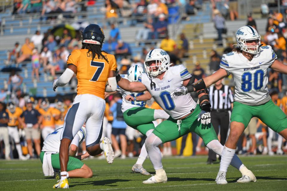 University of West Florida defensive lineman Jacob Dorn (0) reaches out to block a Mississippi College defender during an extra point against the Choctaws on Saturday, Nov. 4, 2023, in Clinton, Mississippi.
