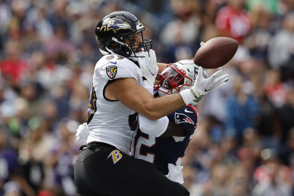 Baltimore Ravens tight end Mark Andrews, left, catches a touchdown pass as New England Patriots safety Devin McCourty, right, tries to defend in the first half of an NFL football game, Sunday, Sept. 25, 2022, in Foxborough, Mass. (AP Photo/Michael Dwyer)