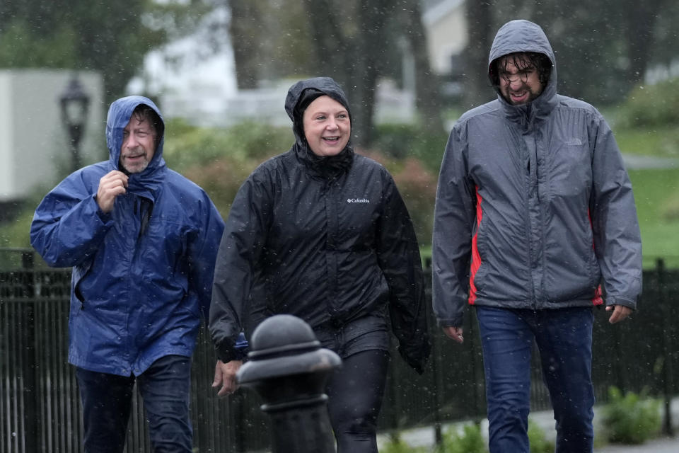 Visitors walk along the waterfront in strong wind and rain as weather associated with Hurricane Lee hits the region, Saturday, Sept. 16, 2023, in Bar Harbor, Maine, (AP Photo/Robert F. Bukaty)
