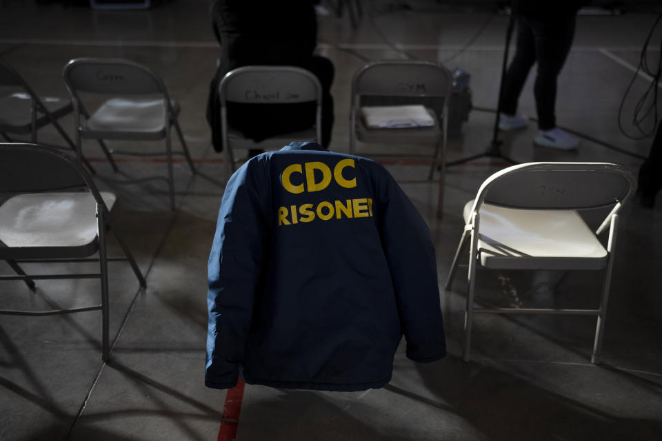 A prisoner's jacket hangs on a chair during a special screening of Sol Guy's personal documentary film at Valley State Prison's gymnasium in Chowchilla, Calif., Friday, Nov. 4, 2022. The gym had been closed for recreational activities like basketball as part of ongoing COVID restrictions. About 150 prisoners were allowed in for the film – individual bags of buttered popcorn and cold beverages included with admission – their excitement palpable after many months of isolation. (AP Photo/Jae C. Hong)