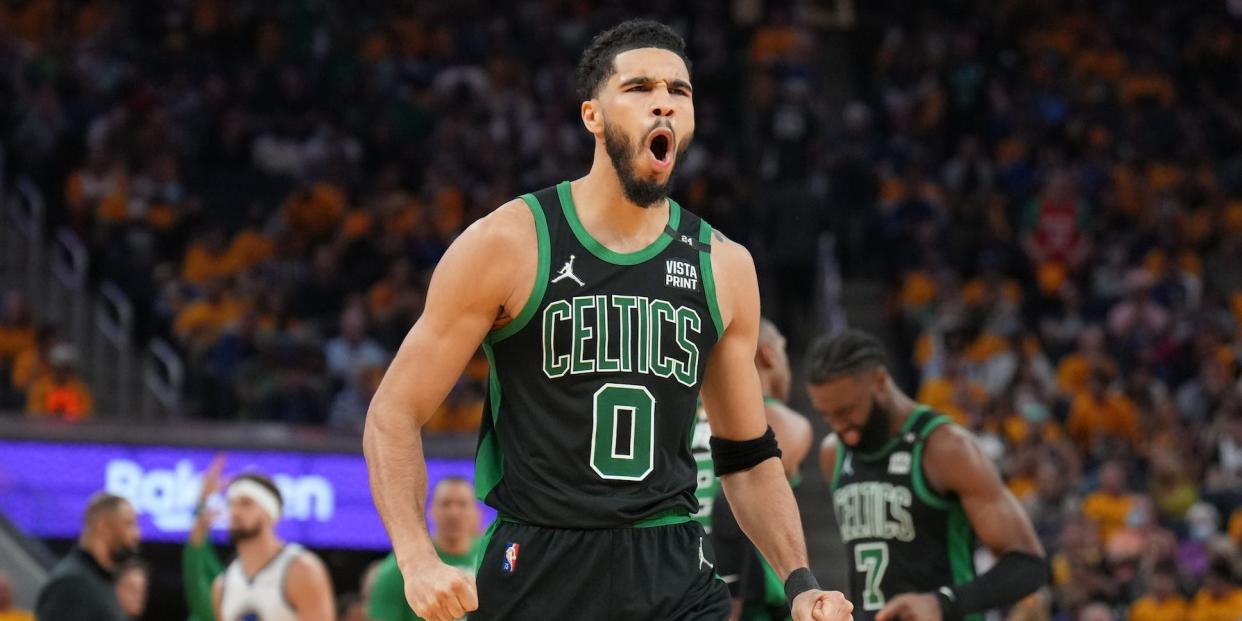 Jayson Tatum clenches his fists and yells in celebration during the NBA Finals.
