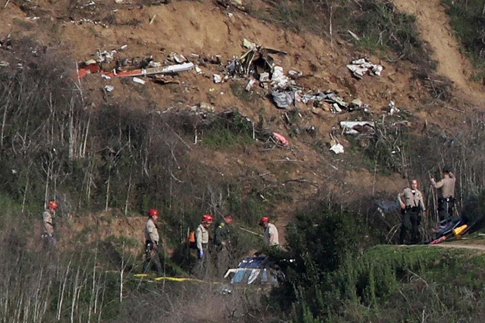 Sherriffs and officials investigate the helicopter crash site of NBA star Kobe Bryant (REUTERS)