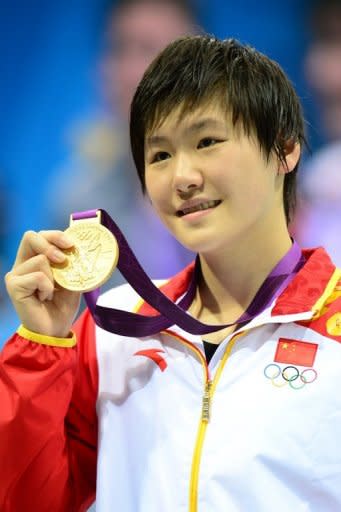 Gold medalist China's Ye Shiwen celebrates on the podium after the women's 200m individual medley final, during the swimming event at the London 2012 Olympic Games, on July 31, in London