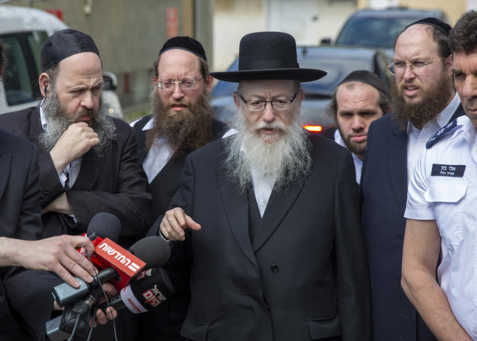 In this Monday, March 2, 2020 photo, Israel's Health Minister Yaakov Litzman delivers a statement as he visits a makeshift tent for quarantined coronavirus voters in Tel Aviv, Israel. Litzman, who has had frequent contact with Prime Minister Benjamin Netanyahu and other top officials, has the new coronavirus, the Health Ministry announced Thursday. (AP Photo/Ariel Schalit)